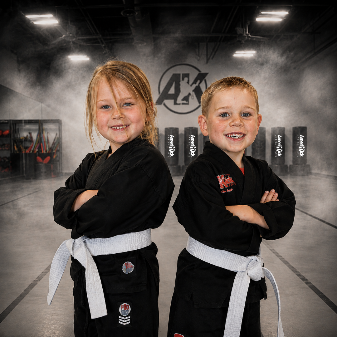 Two beginner students with white belts smiling in the AmeriKick dojo